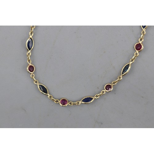 15 - Hallmarked 9ct yellow gold sapphire and ruby chain link bracelet, comprised of alternating bezel-set... 