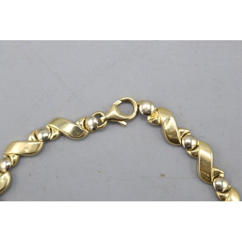 14 - Stamped 18ct yellow gold stylised S-link bracelet with interspersed circular links and lobster claw ... 
