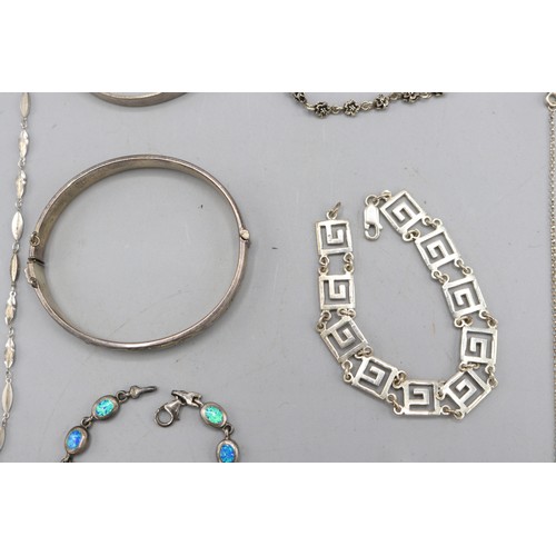 59 - Mixed lot of silver jewellery, comprised of two sterling silver hinged bangles, a sterling silver ma... 