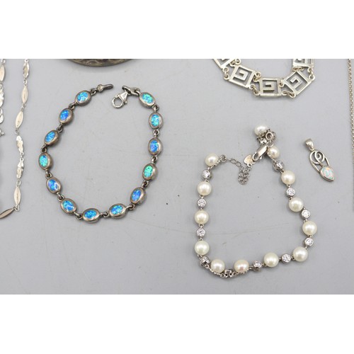 59 - Mixed lot of silver jewellery, comprised of two sterling silver hinged bangles, a sterling silver ma... 