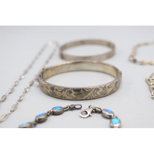 59 - Mixed lot of silver jewellery, comprised of two sterling silver hinged bangles, a sterling silver ma... 