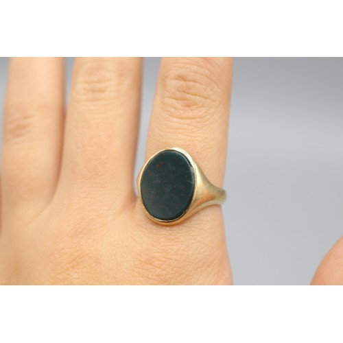 4 - Stamped 9ct yellow gold bloodstone signet ring, comprising a 16 × 12mm oval bloodstone head, set wit... 