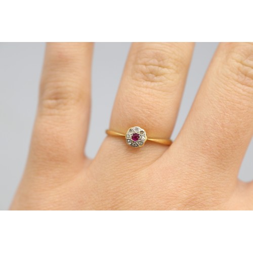 32 - 18ct yellow gold and platinum ruby and diamond halo ring, comprising a central ruby, approximately 0... 