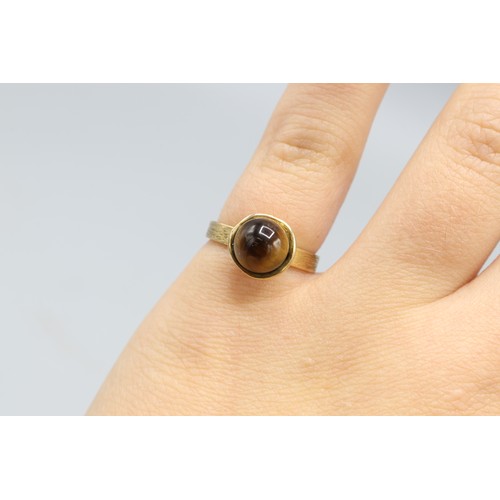 29 - Hallmarked 9ct yellow gold tiger's eye bead solitaire ring, comprising a 7.5mm tiger's eye bead cup-... 