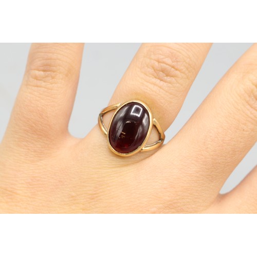 39 - Hallmarked 9ct yellow gold cabochon rhodolite solitaire ring, comprising one oval cabochon rhodolite... 