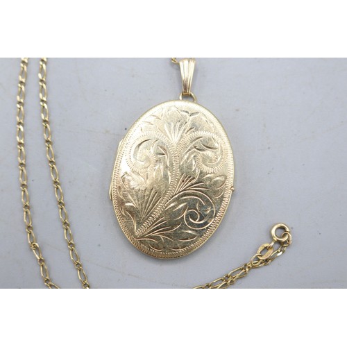 51 - Large hallmarked 9ct yellow gold oval hinged locket with scrollwork-engraved front and fluted bail, ... 