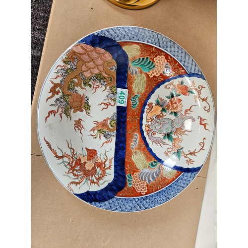 409 - Large oriental charger. Decorated to front and back 

37cm across