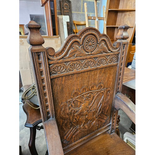 21 - Ornately carved oak Wainscot carvery chair. Carved with dragon in shield.