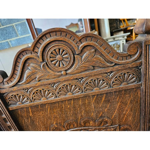 21 - Ornately carved oak Wainscot carvery chair. Carved with dragon in shield.