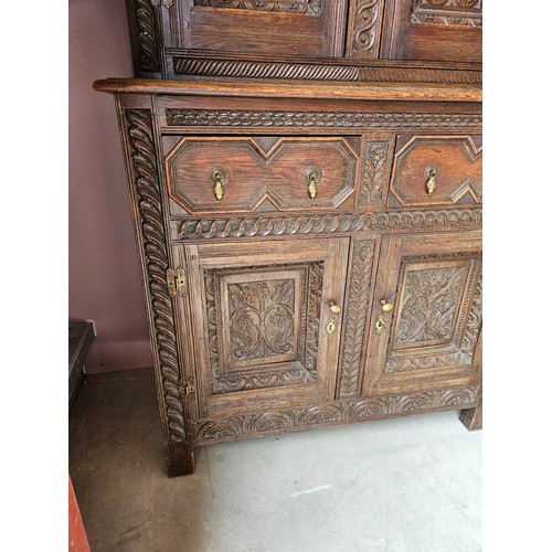 22 - Antique deeply carved oak court cupboard. Splits in two pieces.