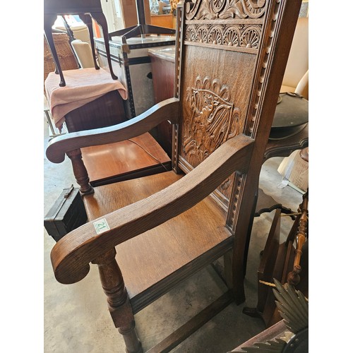 21 - Ornately carved oak Wainscot carvery chair. Carved with dragon in shield.