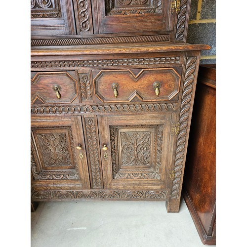 22 - Antique deeply carved oak court cupboard. Splits in two pieces.