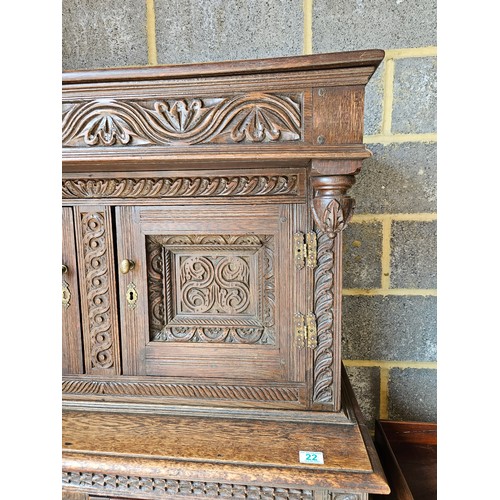 22 - Antique deeply carved oak court cupboard. Splits in two pieces.