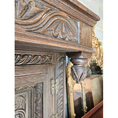 22 - Antique deeply carved oak court cupboard. Splits in two pieces.