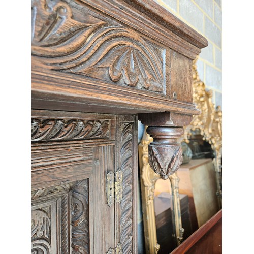 22 - Antique deeply carved oak court cupboard. Splits in two pieces.