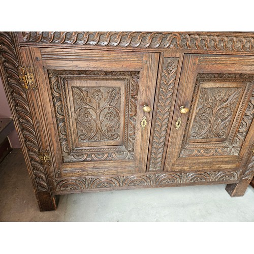 22 - Antique deeply carved oak court cupboard. Splits in two pieces.