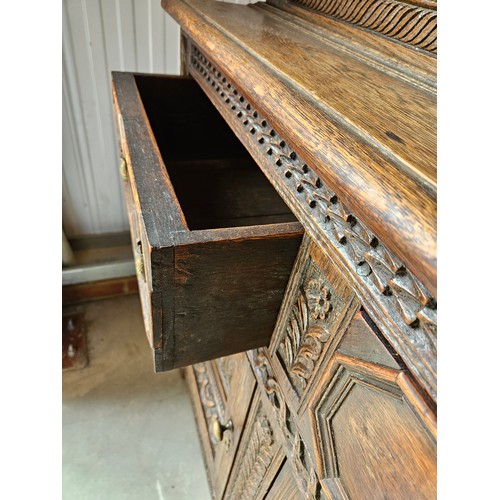 22 - Antique deeply carved oak court cupboard. Splits in two pieces.