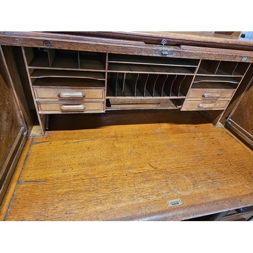 41 - Antique oak 1920's roll top desk. With fitted interior with smaller drawers. The desk breaks down fo... 