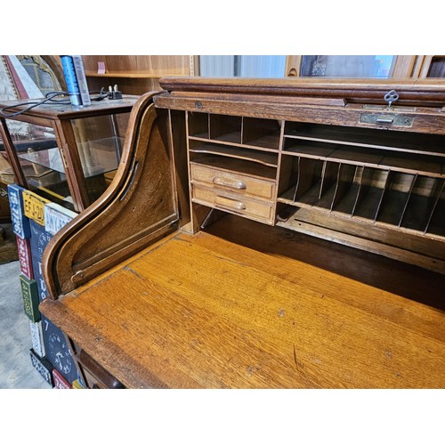 41 - Antique oak 1920's roll top desk. With fitted interior with smaller drawers. The desk breaks down fo... 