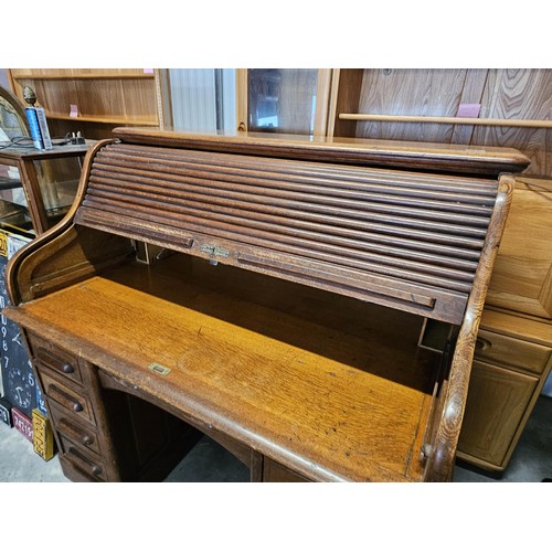 41 - Antique oak 1920's roll top desk. With fitted interior with smaller drawers. The desk breaks down fo... 