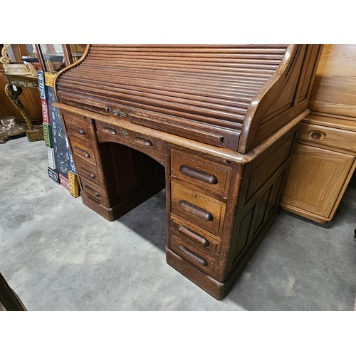 41 - Antique oak 1920's roll top desk. With fitted interior with smaller drawers. The desk breaks down fo... 