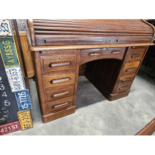 41 - Antique oak 1920's roll top desk. With fitted interior with smaller drawers. The desk breaks down fo... 