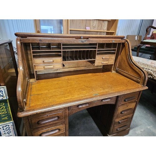 41 - Antique oak 1920's roll top desk. With fitted interior with smaller drawers. The desk breaks down fo... 