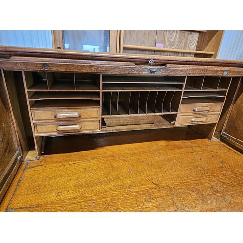 41 - Antique oak 1920's roll top desk. With fitted interior with smaller drawers. The desk breaks down fo... 