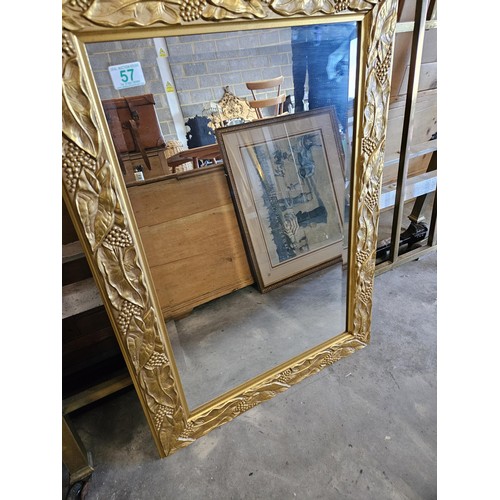 57 - Gold guilt and beveled edge mirror. With leaf decoration