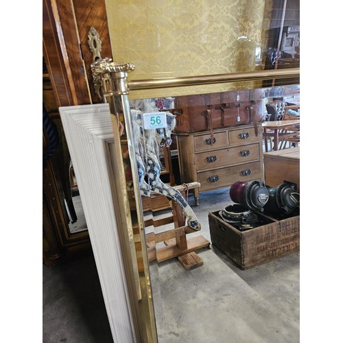 56 - Pair of brass and beveled edge wall hanging mirrors. With fancy decoration