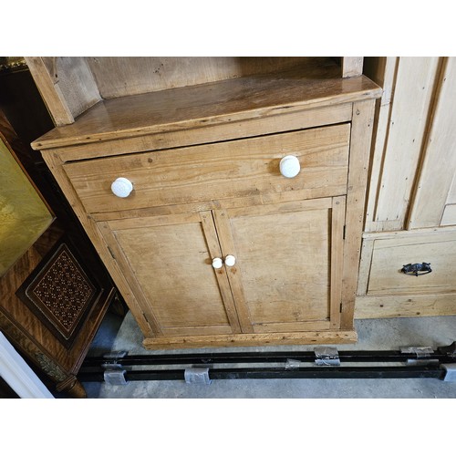 59 - Waxed pine small Welsh dresser with white porcelain handles

90cm wide x 43cm deep x 180cm high