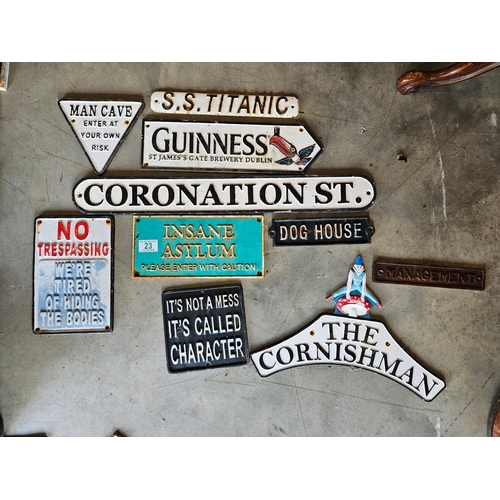 23 - 10 x various cast iron signs 
Including Guinness, Titanic, Coronation St ect