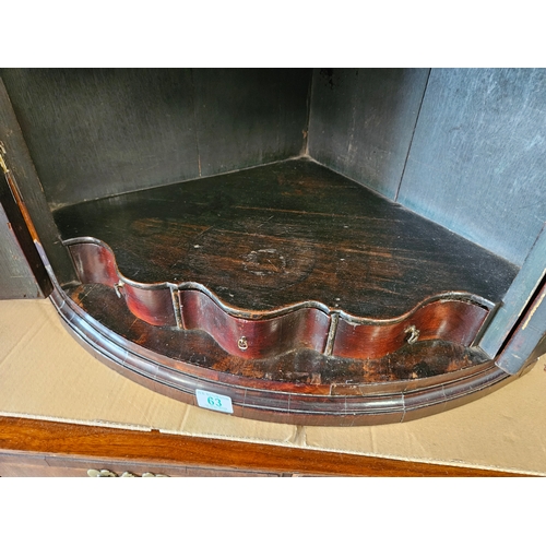 63 - Antique mahogany Georgian corner cupboard with H hinges and scalloped shelves.