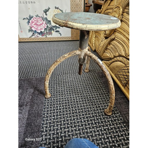 111 - Rustic 3 legged metal stool with wooden seat base.