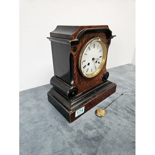 174 - Burr veneer mantel clock, with enamel face and beveled glass.
With pendulum