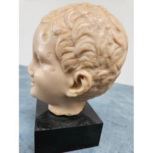 199 - Resin bust of boys head on stand

23cm high