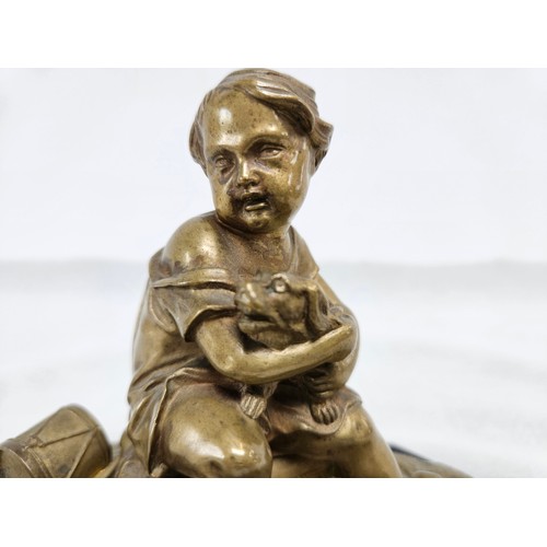 224 - Heavy bronze sculpture of boy on a pillow. Holding a dog.
On a stone/slate base. 

16cm high x 21cm ... 