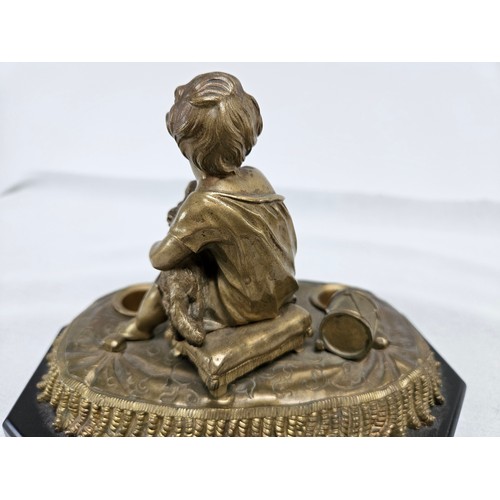 224 - Heavy bronze sculpture of boy on a pillow. Holding a dog.
On a stone/slate base. 

16cm high x 21cm ... 