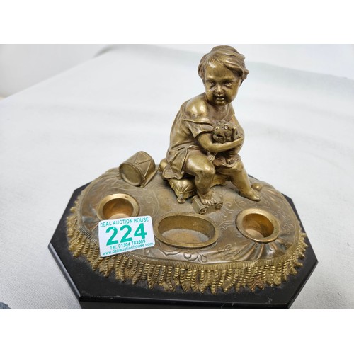 224 - Heavy bronze sculpture of boy on a pillow. Holding a dog.
On a stone/slate base. 

16cm high x 21cm ... 