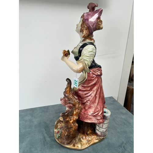 247 - Large Capodimonte ornament of lady 

Chipping to flower 

67cm high x 32cm wide