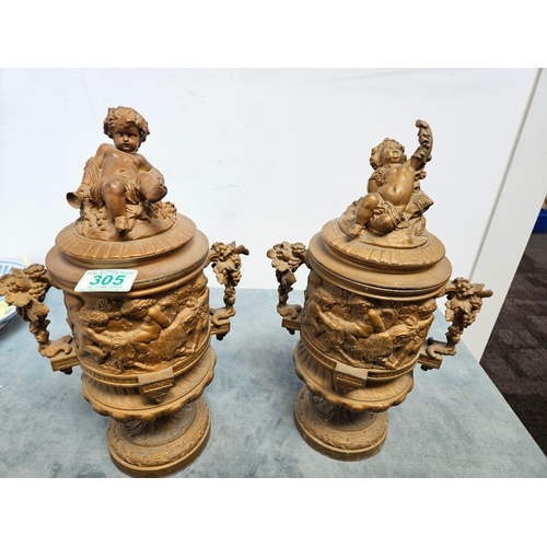 305 - Highly ornate cast & gilt metal urn with lift off lid and cherubs