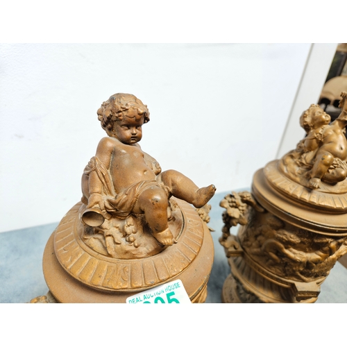 305 - Highly ornate cast & gilt metal urn with lift off lid and cherubs