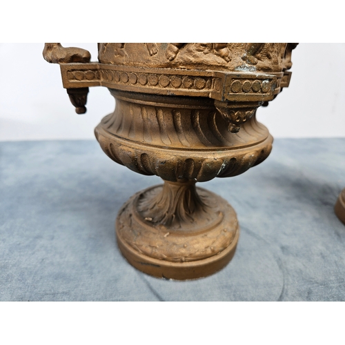 305 - Highly ornate cast & gilt metal urn with lift off lid and cherubs