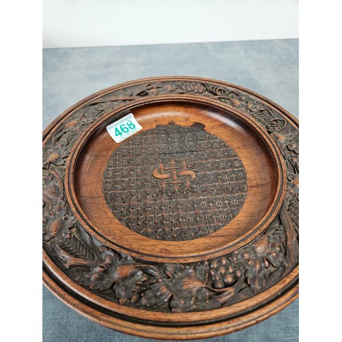 468 - Antique carved wood collection plate.  High quality carvings
29cm across