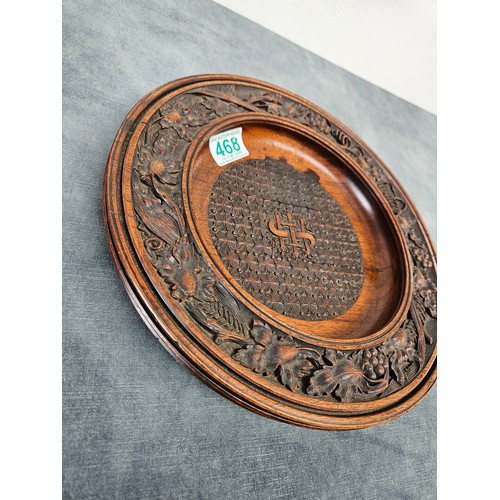 468 - Antique carved wood collection plate.  High quality carvings
29cm across