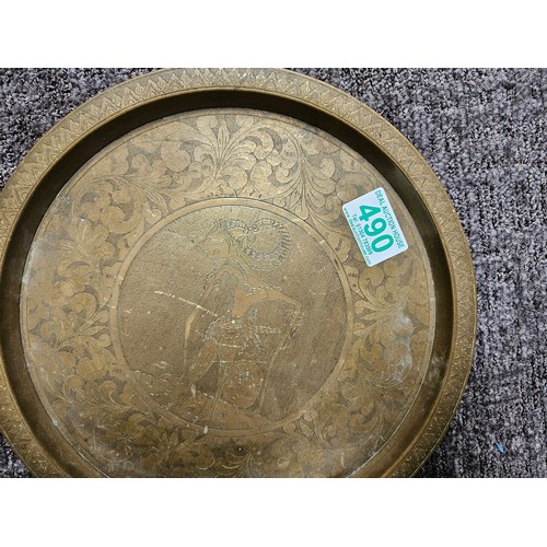 490 - Vintage brass plate with tribal etched figure on it.