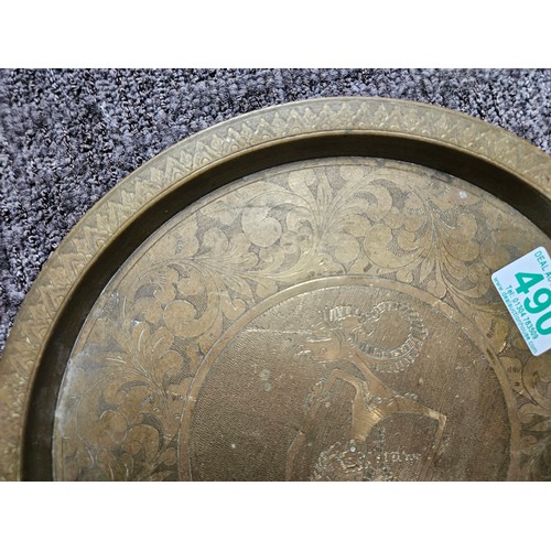 490 - Vintage brass plate with tribal etched figure on it.