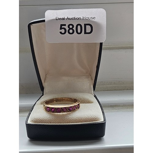 580D - 9ct yellow gold.
Ruby and diamond half eternity ring.
3.19g