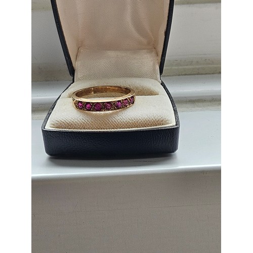 580D - 9ct yellow gold.
Ruby and diamond half eternity ring.
3.19g