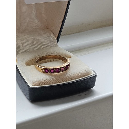 580D - 9ct yellow gold.
Ruby and diamond half eternity ring.
3.19g